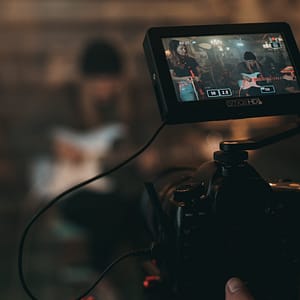 Can You Grow a YouTube Channel When Working Part-Time? Camera on a guitar player - Handshake Marketing Agency